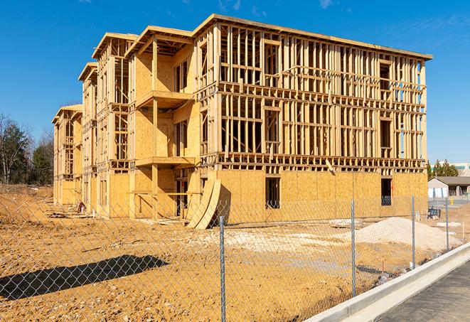 a job site enclosed by temporary chain link fences, ensuring safety for workers and pedestrians in Waynesville